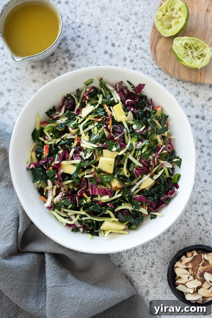 Kale apple slaw with honey lime dressing in a white bowl