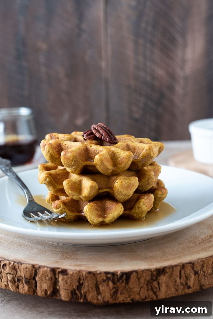 Wholesome Sweet Potato Waffles 2 Stack of healthy gluten-free sweet potato waffles on a white plate, ready to be enjoyed for breakfast