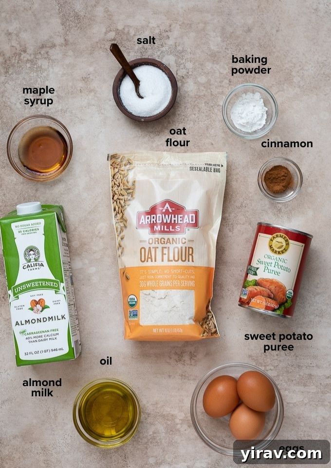 Wholesome Sweet Potato Waffles 4 Collection of sweet potato waffle ingredients including oat flour, sweet potato puree, eggs, milk, and spices