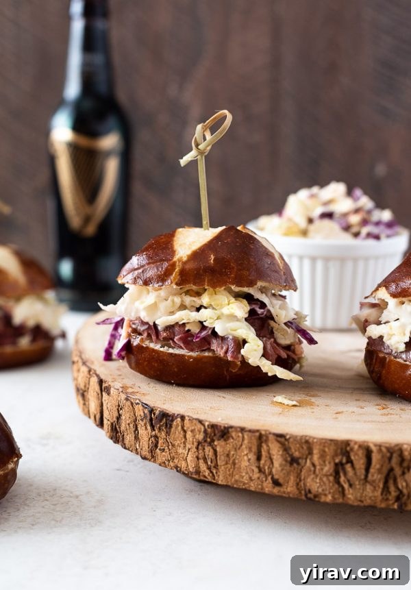 Deli-Style Corned Beef Bites 2 guinness corned beef sliders on serving platter with coleslaw alongside