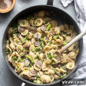 Effortless Spring Garden Pasta 11 One pot pasta primavera with spring vegetables in skillet.