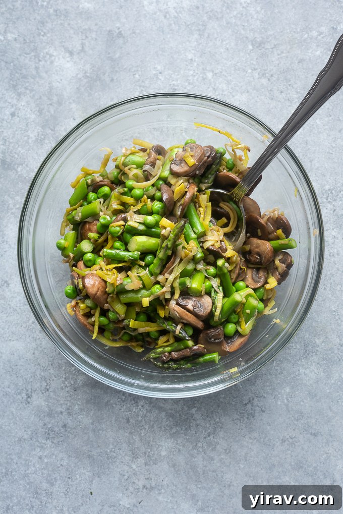 Effortless Spring Garden Pasta 5 Cooked spring vegetables in a bowl.