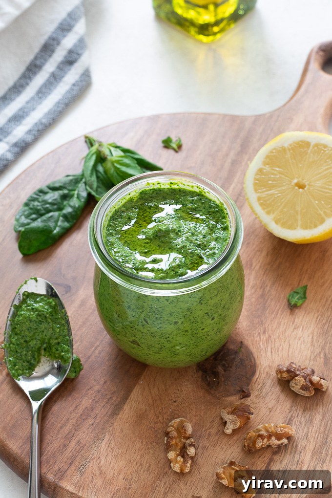 Vibrant Spinach Pesto 3 Spinach walnut pesto in a jar with a spoon alongside