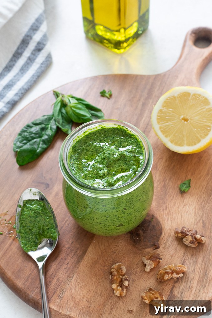 Vibrant Spinach Pesto 6 Spinach pesto in a jar with lemon, walnuts and basil alongside