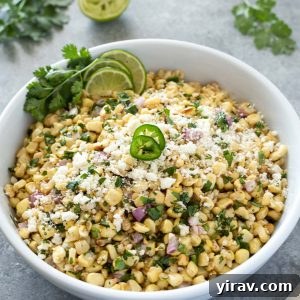 Mexican corn salad in a bowl with jalapeno on top