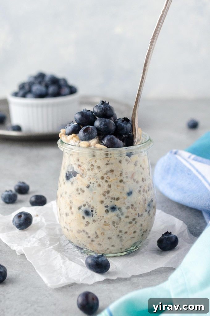 Blueberry overnight oats in a jar with spoon buried inside