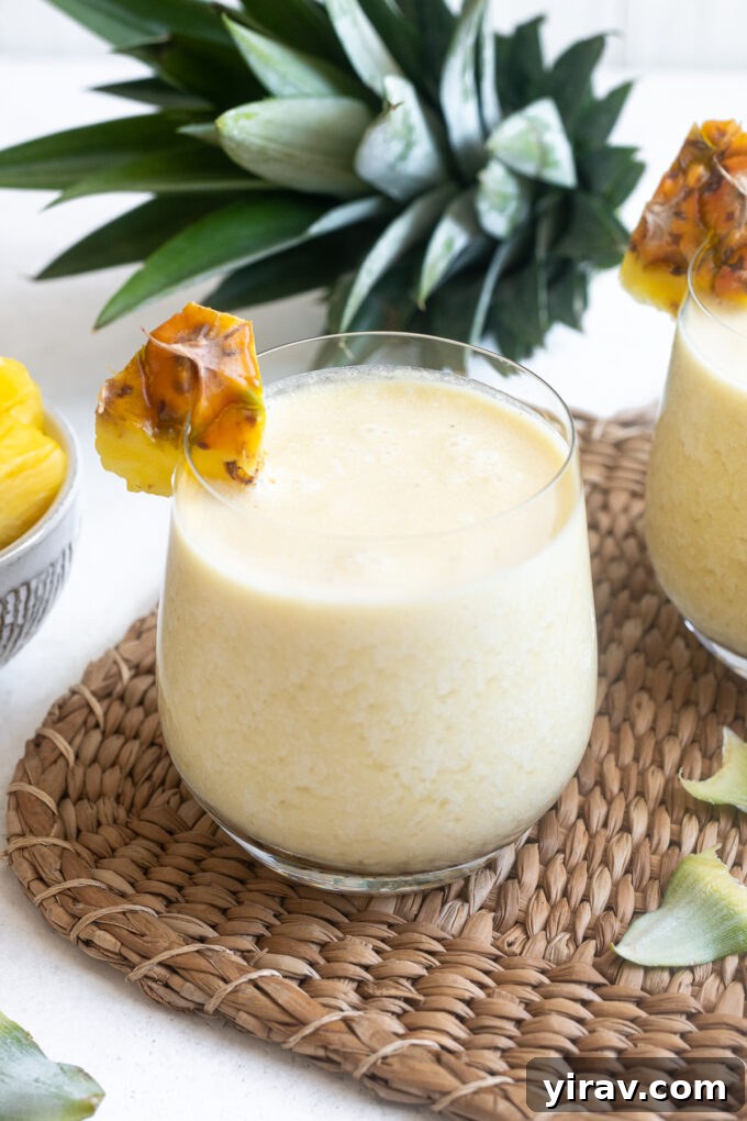 Quick & Creamy Pina Colada Dream 2 Easy pina colada in a high ball glass with pineapple garnish, ready to be enjoyed.