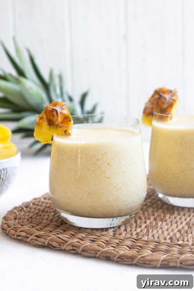 Quick & Creamy Pina Colada Dream 3 Several glasses of piña colada with dark rum poured on top, ready to serve.
