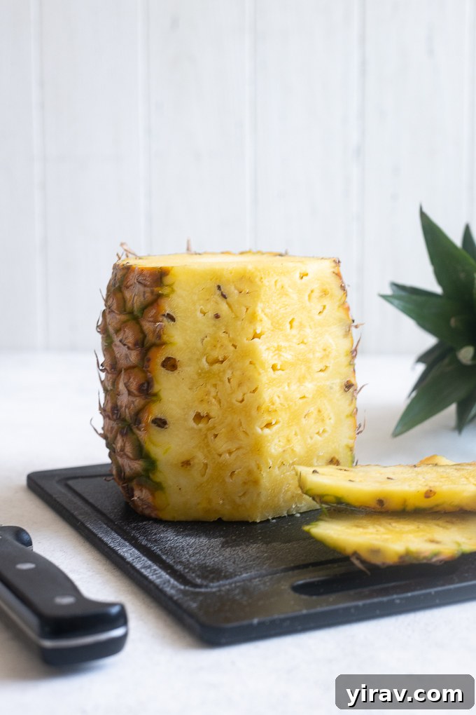 Quick & Creamy Pina Colada Dream 5 Peel carefully cut from a fresh pineapple, revealing the juicy fruit inside.