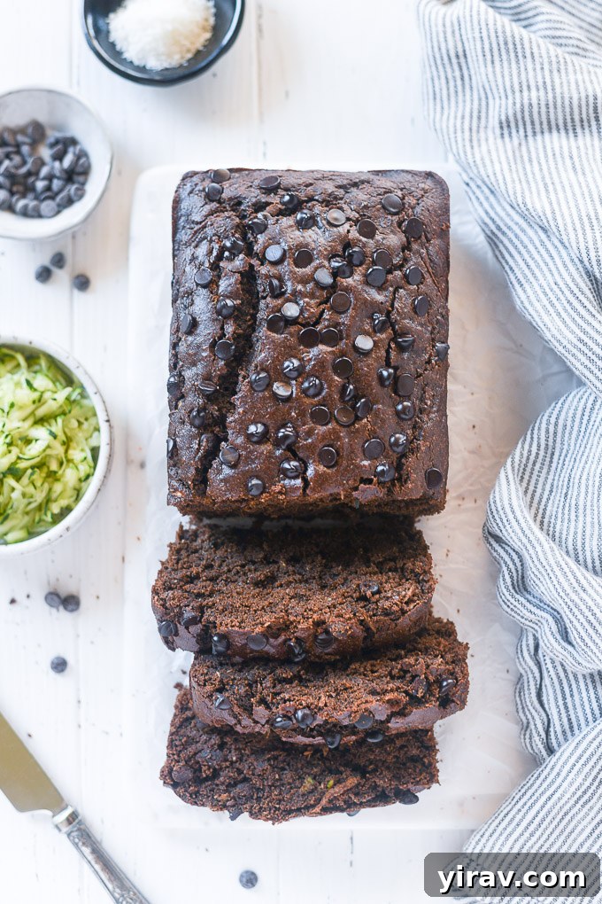 Decadent Double Chocolate Zucchini Loaf 3 Several slices of moist Chocolate Zucchini Loaf arranged neatly on a cutting board, highlighting the dark chocolate chunks.