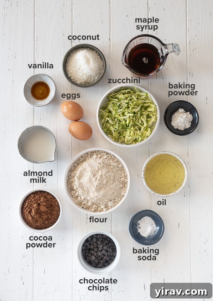 Decadent Double Chocolate Zucchini Loaf 4 A flat lay image showing all the dry and wet ingredients neatly arranged for making chocolate zucchini bread.