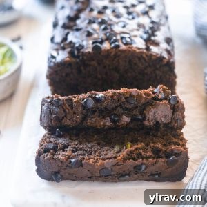 Double chocolate zucchini loaf sliced on a board