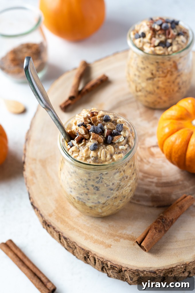 Pumpkin overnight oats in a jar with spoon buried in the middle, ready to eat