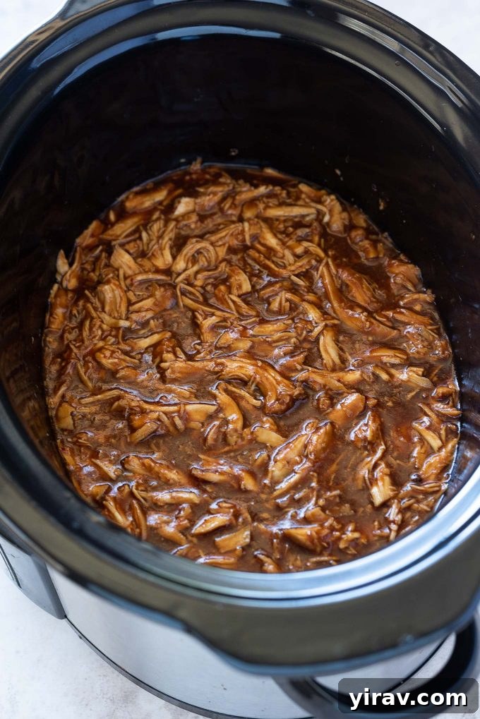 Set-It-and-Forget-It BBQ Pulled Chicken 2 Delicious BBQ pulled chicken served in a slow cooker, ready to be shredded