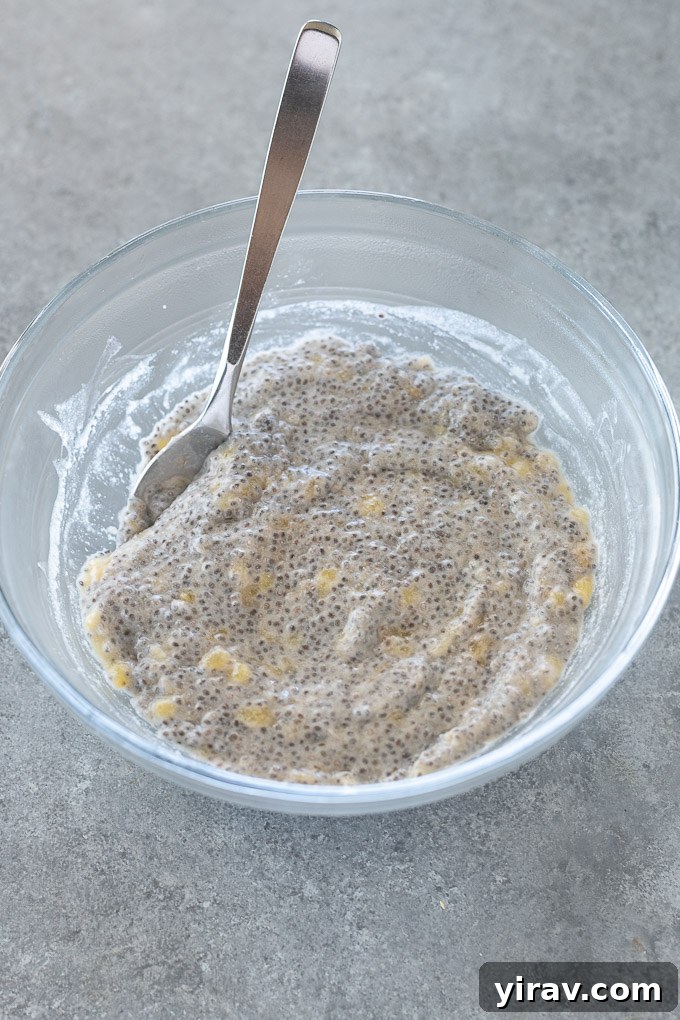 Creamy banana chia seed pudding in a mixing bowl before chilling, showcasing its thick consistency and readiness for refrigeration.