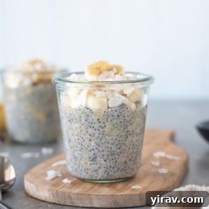 Jar of banana chia pudding on a cutting board, ready to serve.