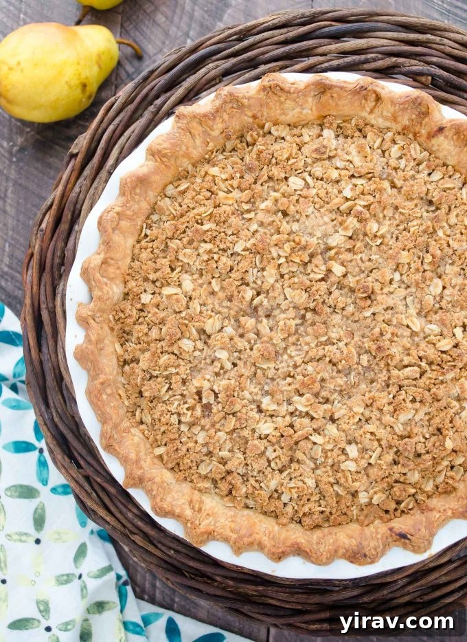 Golden Pear Pie 3 Close-up shot of an entire pear pie with a golden streusel topping, cooling on a wire rack.