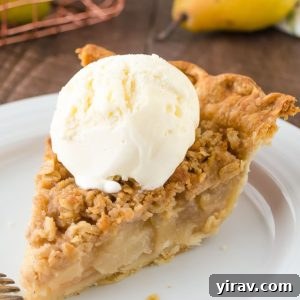 A warm slice of pear pie served with a scoop of melting ice cream.