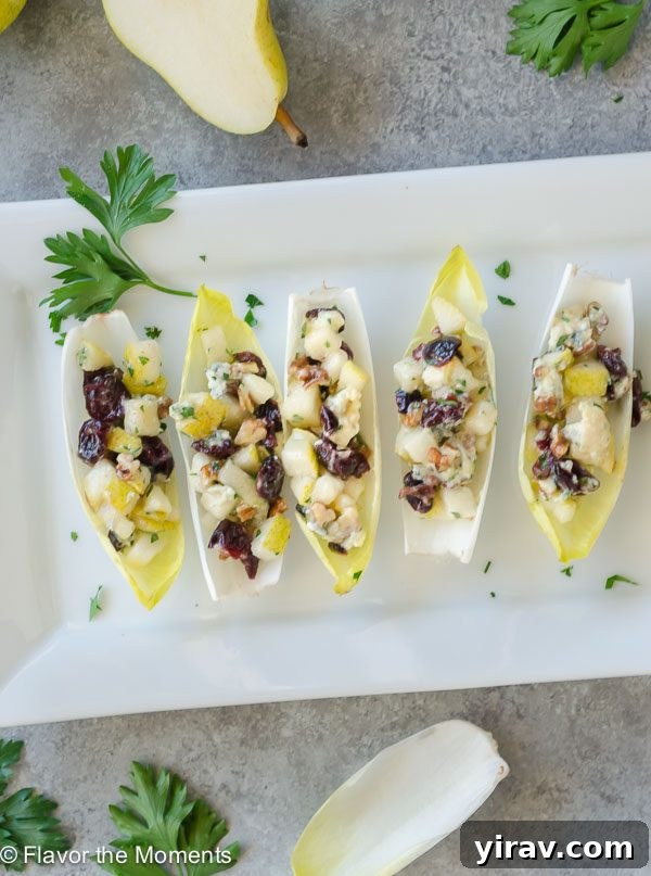 Overhead view of several Endive Salad Bites, garnished with fresh parsley.