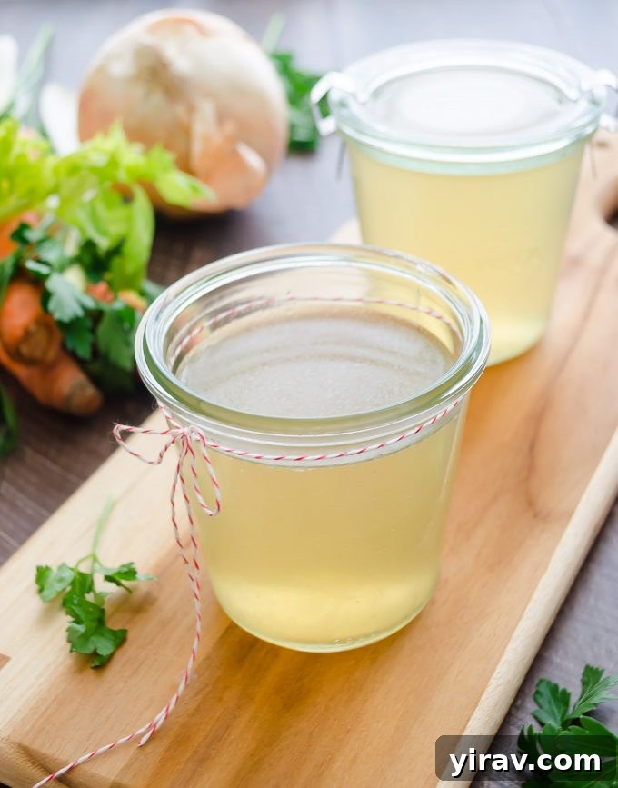 Turkey stock in jars with vegetables in background