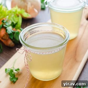 Turkey stock in jars with vegetables in background
