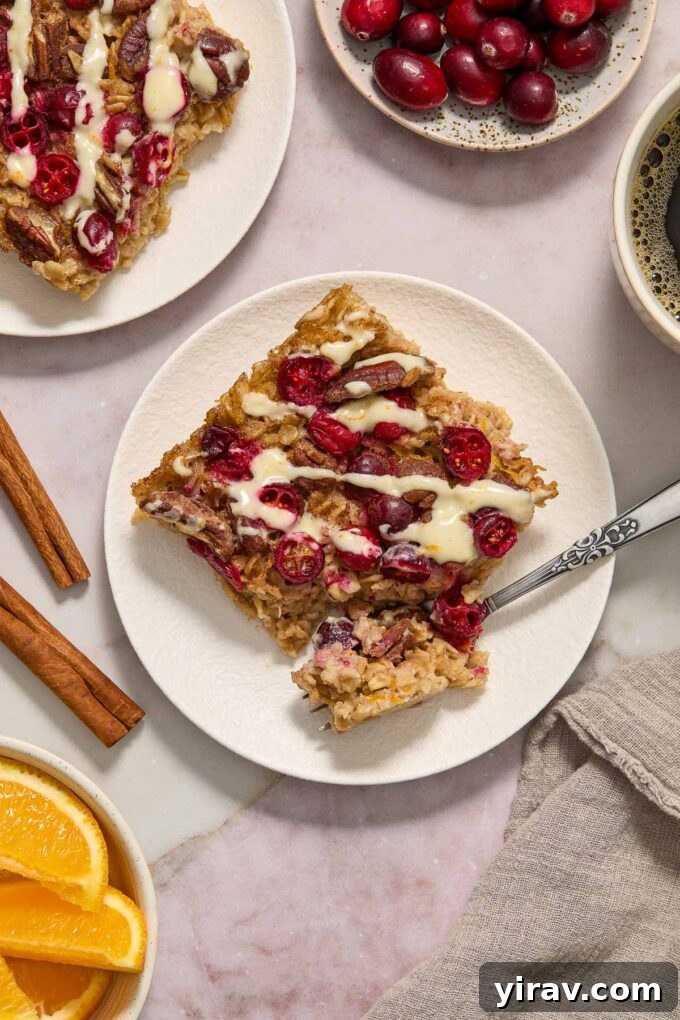 Cranberry oatmeal with orange glaze on a plate.