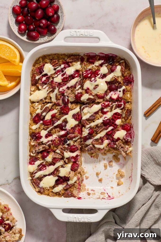 Cranberry baked oatmeal in baking dish with slice removed.