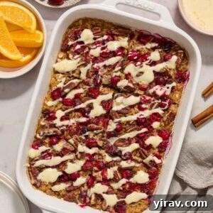Baked cranberry oatmeal with orange glaze in baking dish.