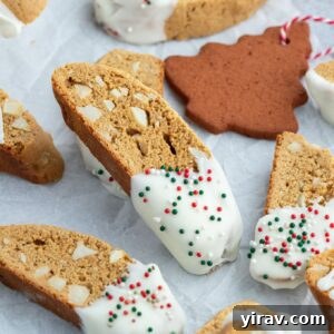 Gingerbread biscotti dipped in white chocolate with sprinkles