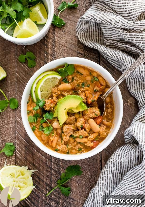 overhead shot of white bean turkey chili with spoon