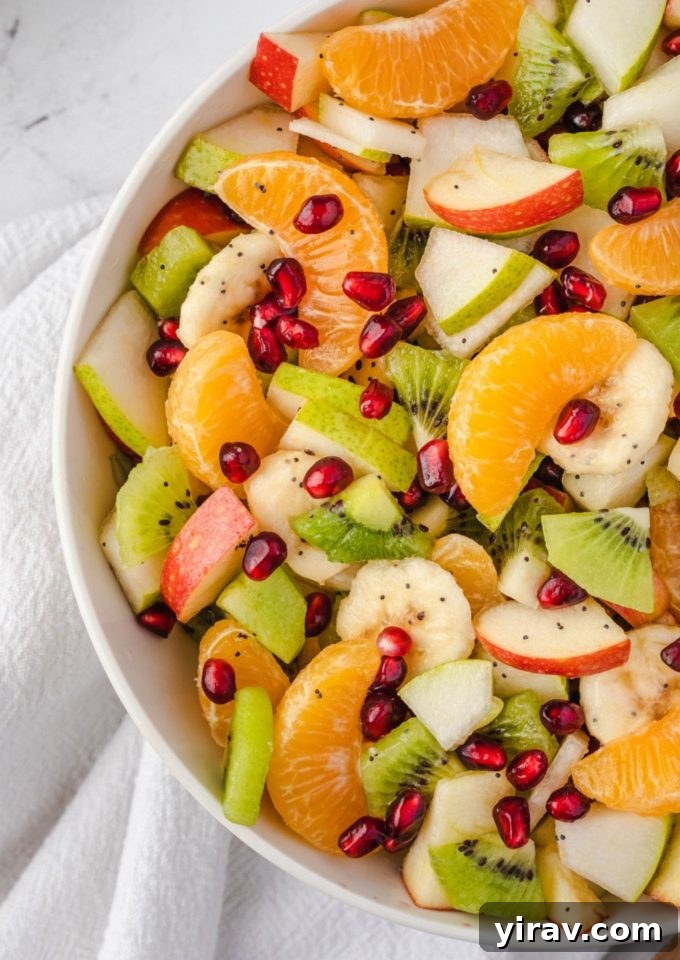Winter fruit salad in a white bowl, showcasing vibrant colors