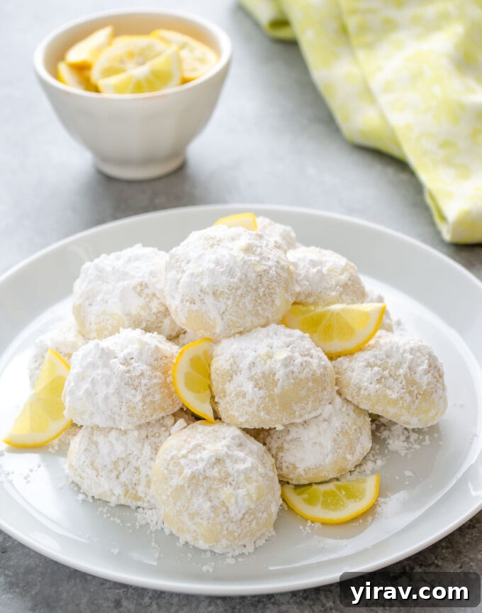 Meyer lemon Greek butter cookies on a plate with lemon slices.