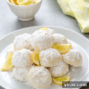 Meyer lemon Greek butter cookies on a plate with lemon slices.