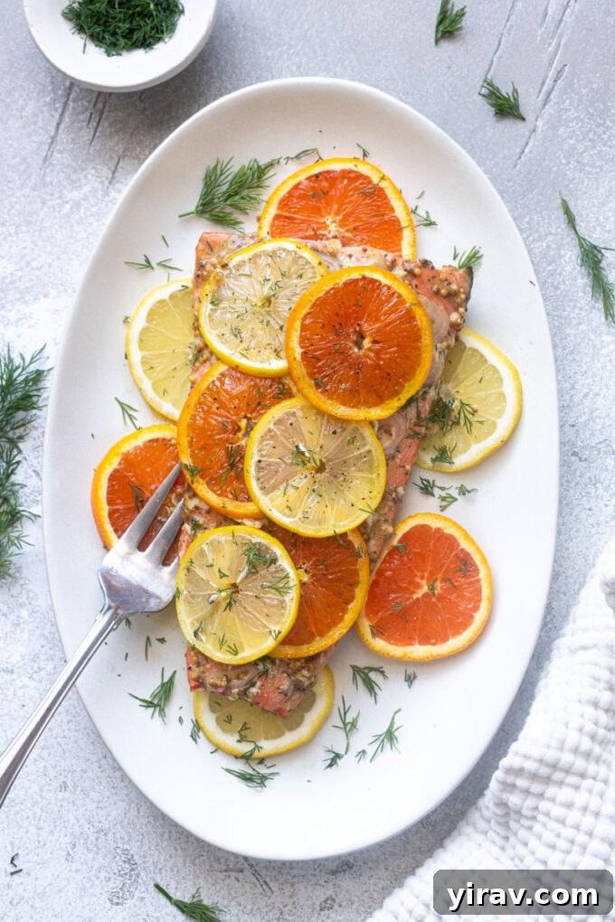 Overhead view of baked citrus salmon with Dijon, lemon and orange.