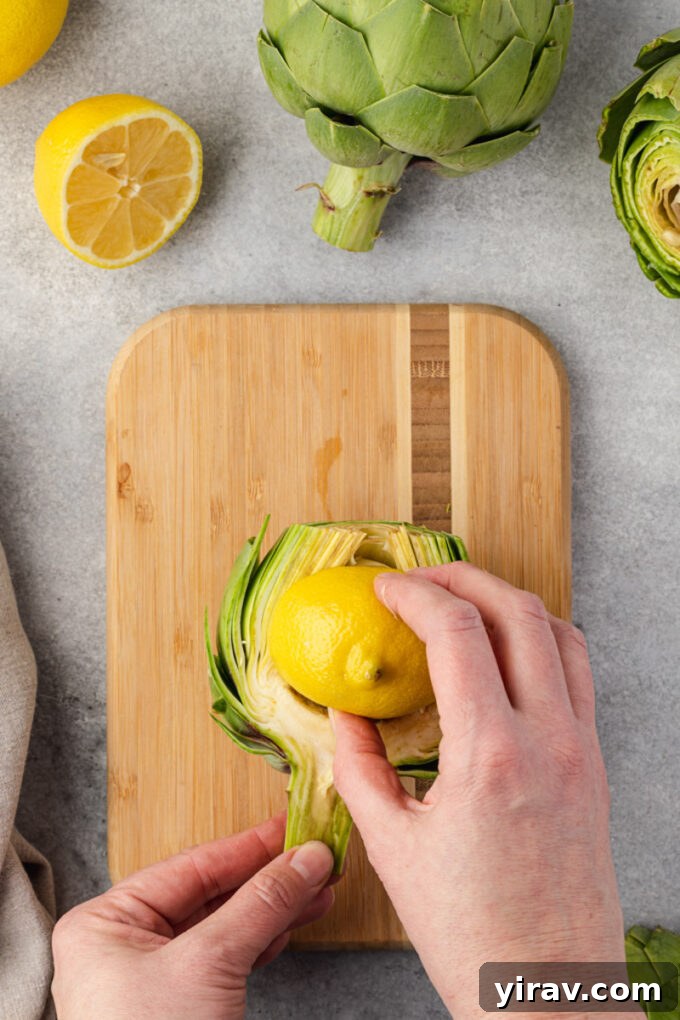Rubbing lemon on cut artichoke to prevent browning.