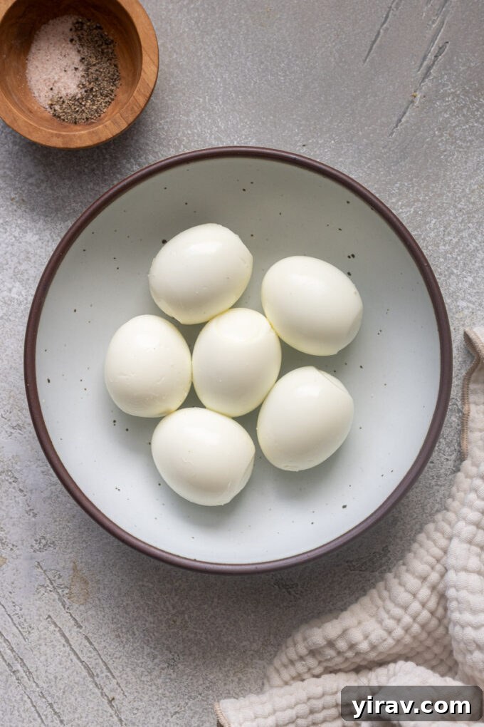 Peeled air fryer hard boiled eggs beautifully arranged in a rustic bowl.