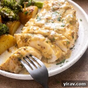 Plated honey mustard chicken with roasted potatoes and broccoli.