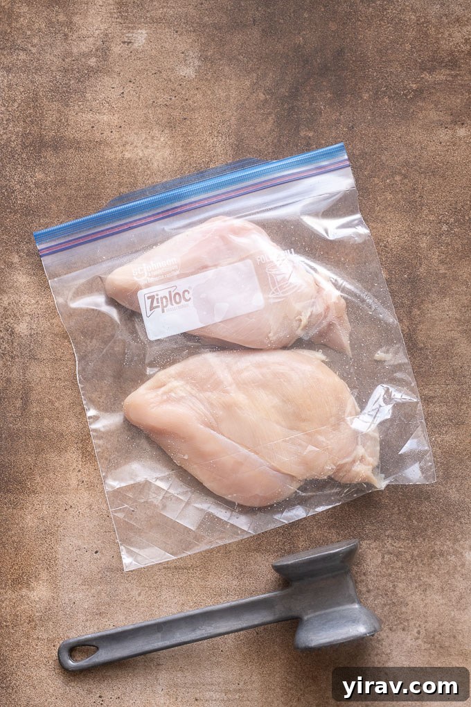 Chicken breasts pounded to even thickness in a zip top bag.