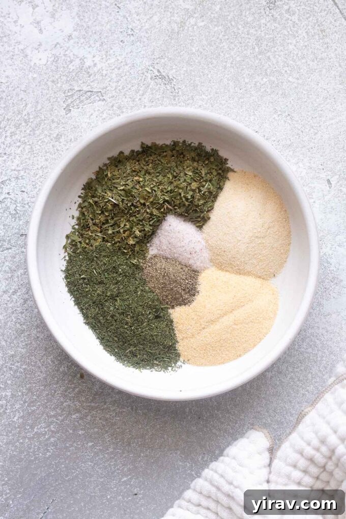 Ranch seasoning ingredients sectioned out in a white bowl.