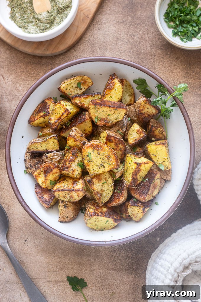 Ranch roasted potatoes in a bowl with parsley sprigs.