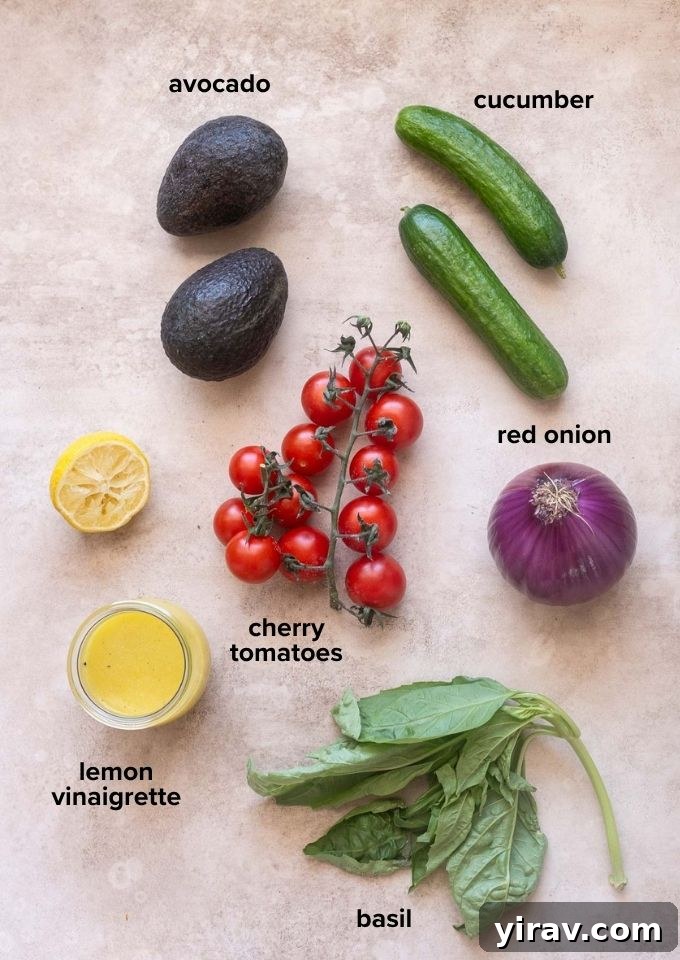 ingredients for cucumber tomato avocado salad with basil and lemon vinaigrette.