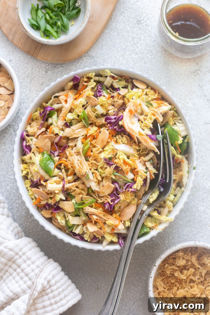 Crisp Asian Chicken Salad with Sesame Ginger Dressing 2 Chinese chicken salad with serving spoons digging into bowl.