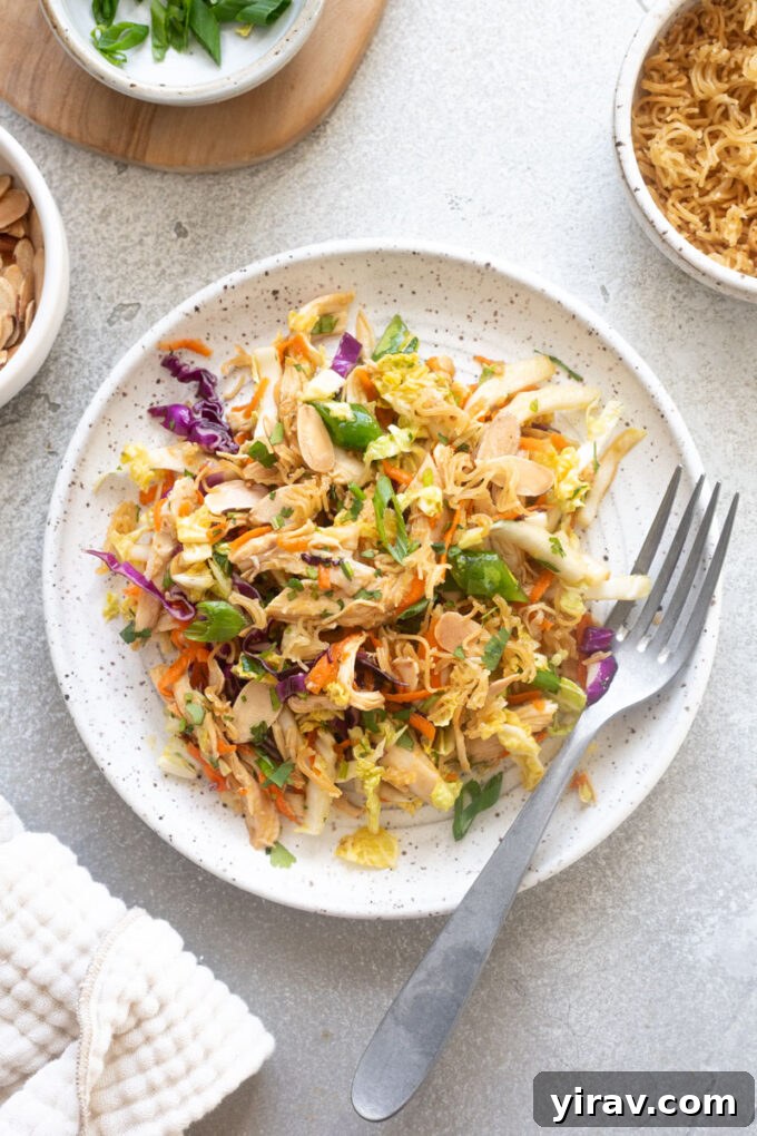 Crisp Asian Chicken Salad with Sesame Ginger Dressing 10 Asian chicken salad on a plate with a fork.