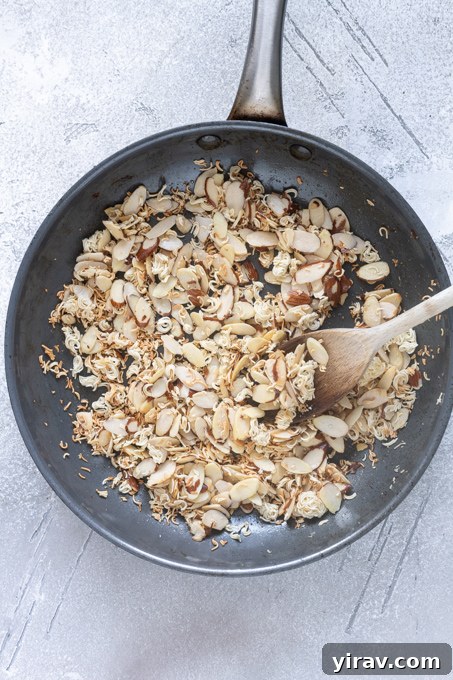 Crisp Asian Chicken Salad with Sesame Ginger Dressing 7 Toasted ramen noodles and almonds in a skillet.
