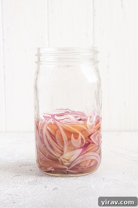 How to Make Quick Tangy Pickled Red Onions in 15 Minutes 10 Jar of sliced red onions in brine.
