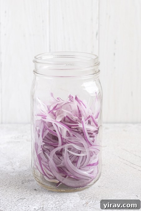 How to Make Quick Tangy Pickled Red Onions in 15 Minutes 7 Sliced onions in a jar.