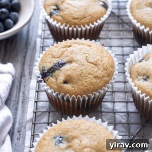 Blueberry Muffins Made with Oat Flour — Moist & Gluten-Friendly 10 Blueberry Oat Flour Muffins on a wire rack.