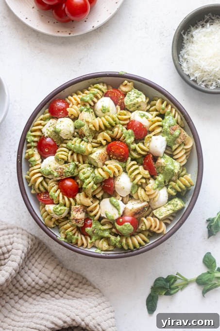 Finished chicken pesto pasta salad in mixing bowl.