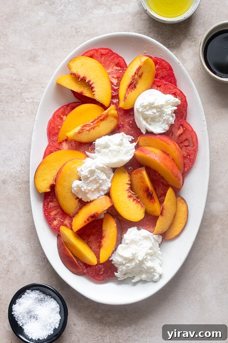 Tomato and Peach Burrata Salad Recipe 7 Heirloom tomatoes and peaches with creamy burrata on top.