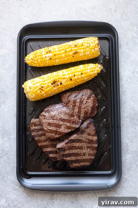 Grilled steaks and corn on the cob for grilled steak salad.